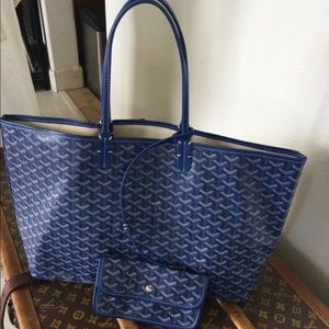 Blue bag with attached small pursesays Goyard